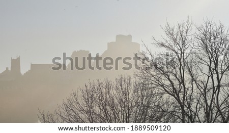 Launceston Castle Cornwall silhouetted in a Winter mist