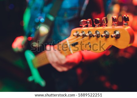 Closeup of blurry male hands playing the guitar.