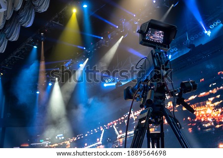 Professional digital video camera. tv camera in a concert hal. Royalty-Free Stock Photo #1889564698