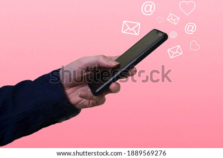 boy using phone with smartphone and social media concept. Pink background