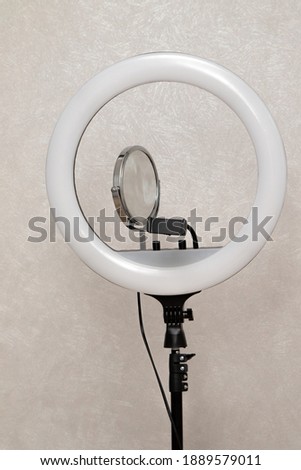 round lighting lamp on a tripod in the room