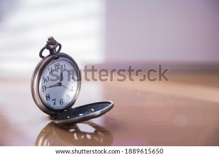 Old antique metallic pocket opened watch. time 12:45, noon hour. Watch arrows, passing time, life, deadline Royalty-Free Stock Photo #1889615650