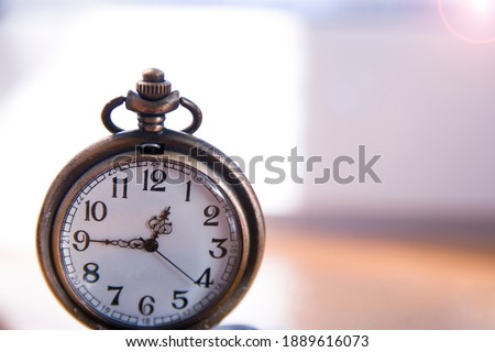 Old antique metallic pocket opened watch. time 12:45, noon hour. Watch arrows, passing time, life, deadline Royalty-Free Stock Photo #1889616073