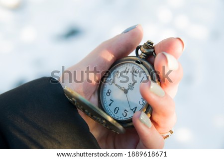 Old antique metallic pocket opened watch. time 12:45, noon hour. Watch arrows, passing time, life, deadline Royalty-Free Stock Photo #1889618671