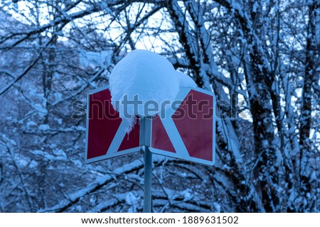  Turn traffic sign under snow, showing the way