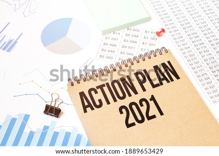 Notepad with text ACTION PLAN 2021. Diagram and white background