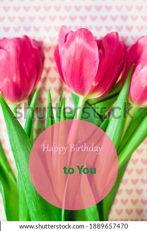 Greeting card with a picture of beautiful pink tulips on a background with pink hearts, a birthday gift for you