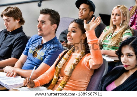 Photo of Female student raising hand during class lecture