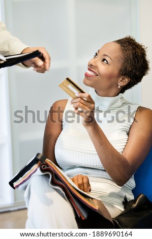 Photo of african american woman making purchase on credit card