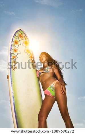 Photo of Female Surfer Making Hang Loose Sign