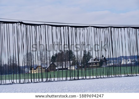 Safety net at the end of runway at Swiss military airport Emmen on a blue cloudy winter day. Photo taken January 8th, 2021, Emmen, Switzerland.