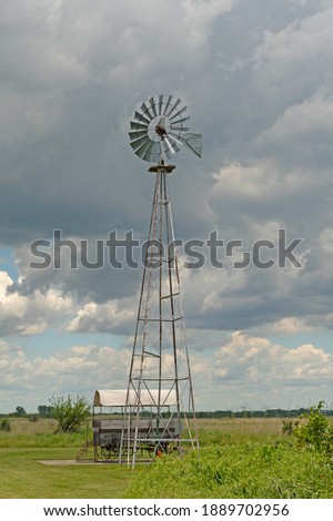 Working Windmill Against the Sky in Goose Lake Prairie State Natural Area in Illinois Royalty-Free Stock Photo #1889702956