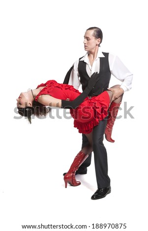 young couple dancing tango in retro costumes on white background