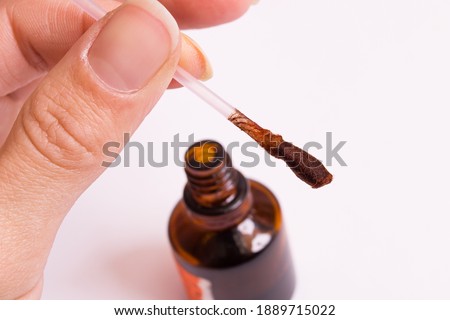 Cotton bud and jar of iodine on a white background
