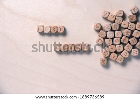 Words denoting next covid consists of wooden cubes with letters. Wooden cubes with letters images. Words denoting next covid word concept