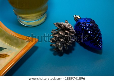 Blue and silver pineapples with blue background and toasted beer
