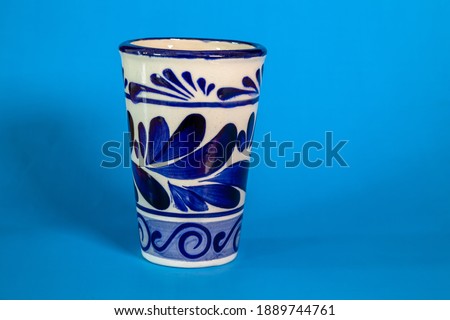 A close up of a Talavera cup with a blue background Royalty-Free Stock Photo #1889744761