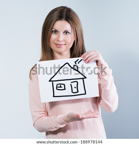 young woman holding picture with house. Photo in color style instagram filters 