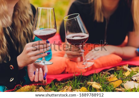 Lovers clinking wine glasses in nature for the love. Cheers Hands holding wine glass. Green background. Bokeh. Celebration. Wedding. Woman, man.