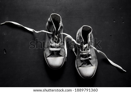 Close up of black and white shoes with dark background