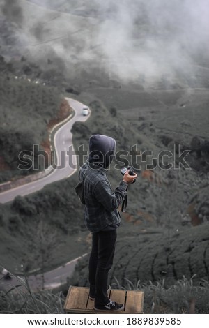 BANDUNG, INDONESIA, JANUARY 09, 2021: When the weather is foggy, Sunrise Point Cukul is a beautiful place to take a picture in South of Bandung. 