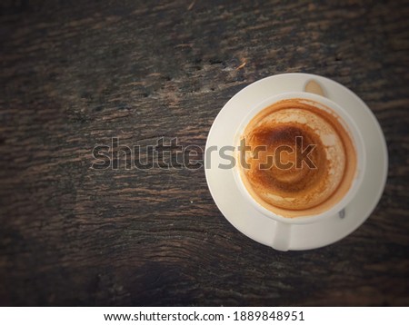 A coffee mug placed on a wooden table. Vintage concept picture , Blurred image
