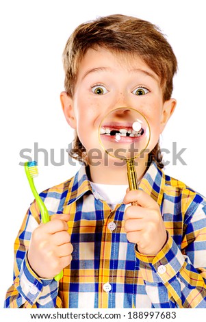 Little funny boy smiling through a magnifying glass, showing his teeth. Healthcare. Isolated over white.