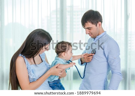 Parents are using a stethoscope to check the symptoms of cute baby boys, Who come to receive treatment for illness from Heart disease and flu to health care and insurance concept. Royalty-Free Stock Photo #1889979694