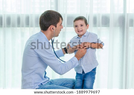 Parents are using a stethoscope to check the symptoms of cute baby boys, Who come to receive treatment for illness from Heart disease and flu to health care and insurance concept. Royalty-Free Stock Photo #1889979697