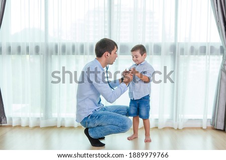 Parents are using a stethoscope to check the symptoms of cute baby boys, Who come to receive treatment for illness from Heart disease and flu to health care and insurance concept. Royalty-Free Stock Photo #1889979766