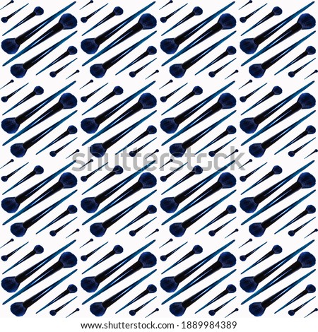Cosmetic brushes in a seamless pattern on a white background, close-up, cosmetics advertising, wallpaper, texture, copy space for text