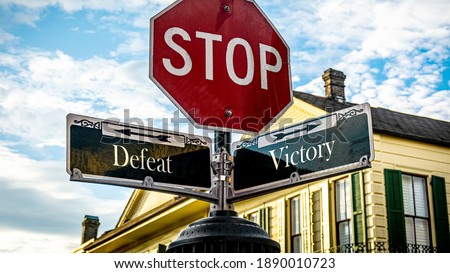 Street Sign the Direction Way to Victory versus Defeat