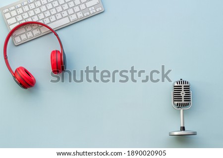 Audio equipment background. Retro microphone and headphones on studio table