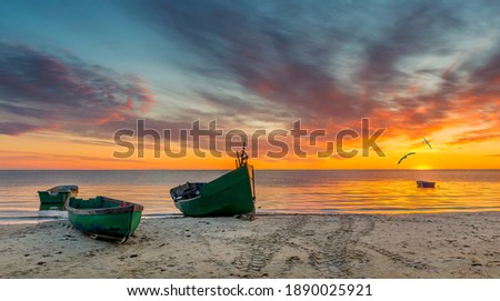 Anchored fishing boats near a small village of fishermen; here at the Baltic Sea, traditional and mighty Latvian fisheries was successfully developed in 19-20-th centuries Royalty-Free Stock Photo #1890025921