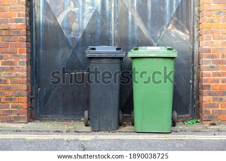 Two wheelie bins side by side outside a home in the UK Royalty-Free Stock Photo #1890038725