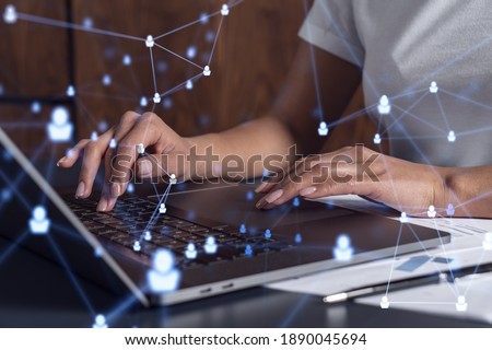 Hands of woman hr specialist is typing the keyboard in the internet to find the best candidates to create international network in recruitment process. Casual wear. Social media hologram icons. Royalty-Free Stock Photo #1890045694