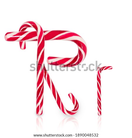 Candy cane in shape of letter R isolated on white background.