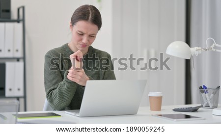 Young Woman with Laptop having Wrist Pain 