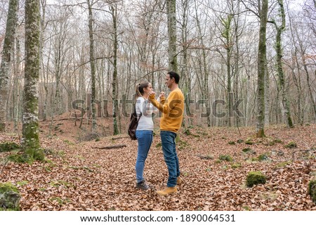 Beautiful young couple giving hands in forest.Romantic concept, love,relationship and friendship lifestyle