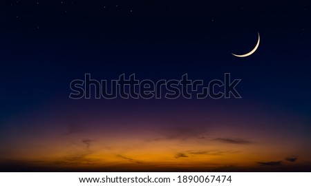 Islamic Moon sky on Dark Blue Dusk,Twilight Sky in the Evening with Sunset and Beautiful Sunlight dark cloud and Crescent moon, symbol of religion islamic begin Ramadan month, Eid al-Adha, Eid al fitr Royalty-Free Stock Photo #1890067474