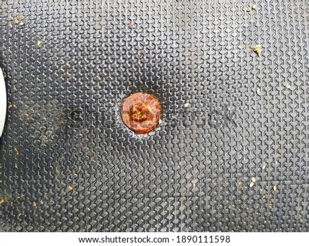 Rusted screw on a car mat close up texture image