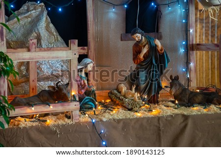 Christmas figures in a large manger, Jesus, Maria, Jose, donkey, ox