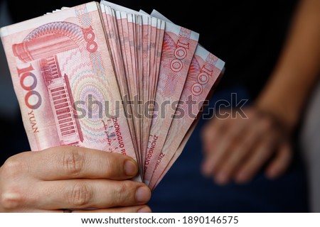 Man holds yuan. Currency of the China - One red hundred renminbi or yuan notes