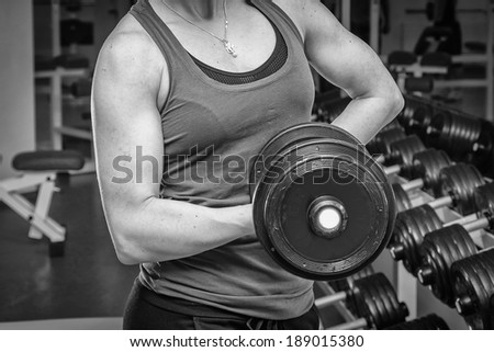 strong woman with dumbbells