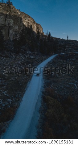 Car driving through a mountain pas and canyon