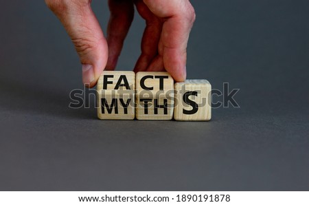 Facts or myths symbol. Businessman hand turns cubes and changes the word 'myths' to 'facts'. Beautiful grey background, copy space. Business and facts or myths concept. Royalty-Free Stock Photo #1890191878