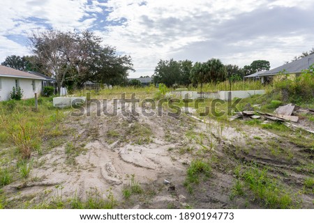 Vacant lot abandoned construction site in Florida gulf coast Royalty-Free Stock Photo #1890194773