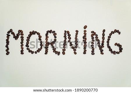 Word Morning made from roasted coffee beans on white background.                              