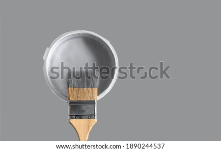 Can with paint of ultimate gray color and paintbrush on ultimate gray background. Copy space for your text. Flat lay.