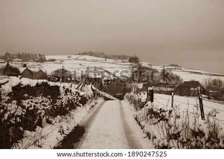 Snow covered lane in winter up on the moors
